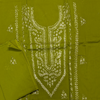 Green fabric with white floral embroidery on a matching green background