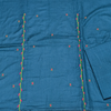 Blue fabric with floral embroidery on a plain background
