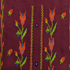 Embroidered fabric with floral patterns on a maroon background